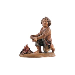 Child kneeling near the fireplace