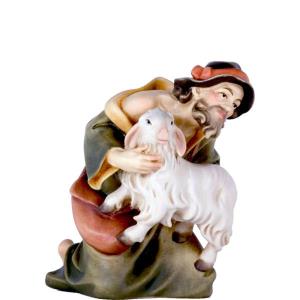 Shepherd kneeling with sheep