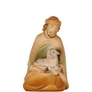 Shepherd kneeling with sheep