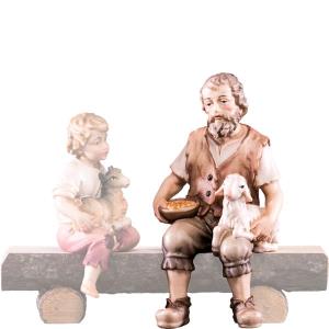 Shepherd sitting with lamb H.K.