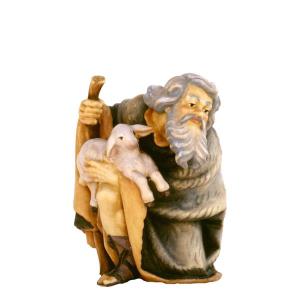 Shepherd kneeling with sheep